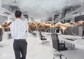 businessman standing in inverted office in clouds