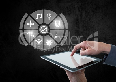 Hand holding tablet with icons interface of internet of things