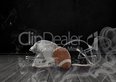 American football and helmets in smoke