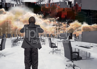 businessman standing in inverted office in the clouds