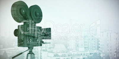 Composite image of black film reel camera with tripod