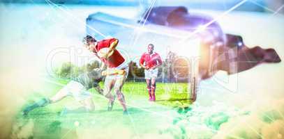 Composite image of rugby players tackling during game