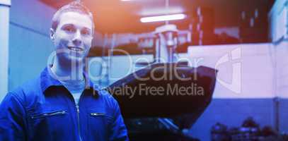 Portrait of male mechanic with digital tablet at garage