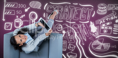 Composite image of woman on her tablet looking up