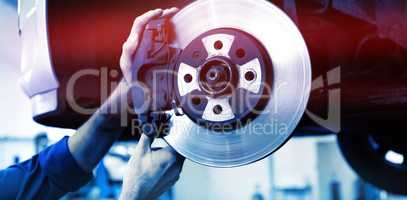 Cropped image of focused mechanic adjusting wheel