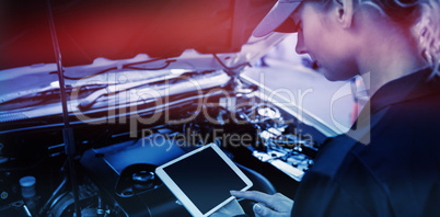 Mechanic girl using a tablet in garage