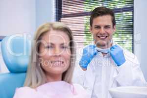 Happy patient and dentist  at dental clinic