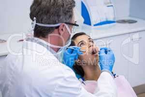 Doctor examining woman mouth