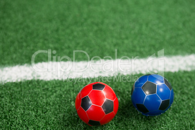 Footballs on artificial grass