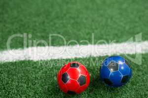 Footballs on artificial grass