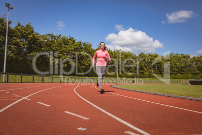 Woman jogging on a race track