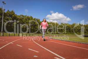 Woman jogging on a race track