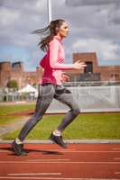 Woman jogging on a race track