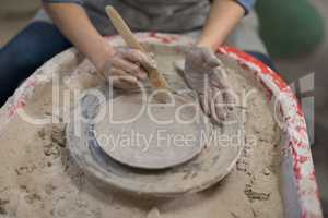 Mid section of female potter molding plate with hand tool