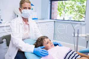 Portrait of dentist standing by boy