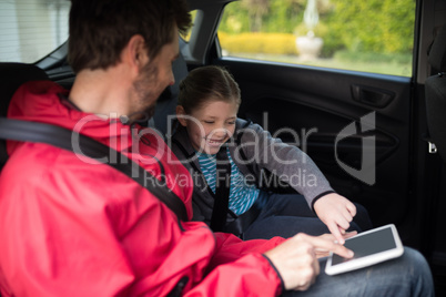 Father and daughter using digital tablet