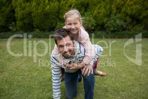 Young girl rides piggyback