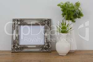 Picture frame and vase on table