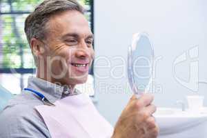 Portrait of smiling man looking in mirror