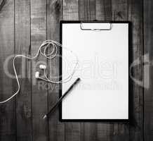 Clipboard, letterhead, pencil, headphones