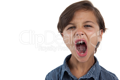 Boy shouting against white background