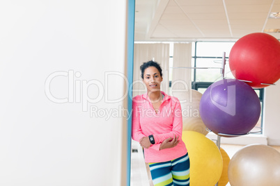 Woman leaning on wall in the gym