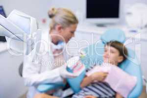 Boy receiving treatment by dentist