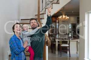 Parents and daughter standing on stairs