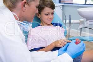 Dentist and boy looking at dentures