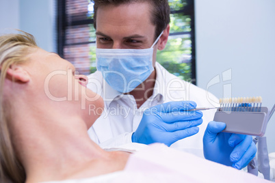 Close up of dentist showing equipment to patient