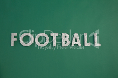 Word football arranged on green background