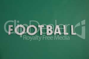 Word football arranged on green background