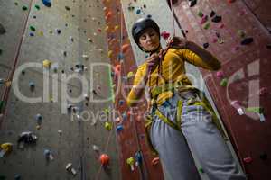 Low angle view of female athlete tying rope in health club