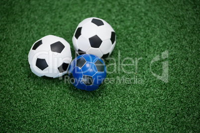 Footballs on artificial grass