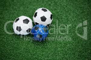 Footballs on artificial grass