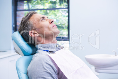 Patient sitting on dentist chair