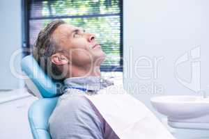 Patient sitting on dentist chair