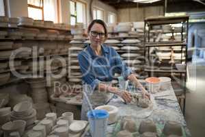 Portrait of female potter molding a clay
