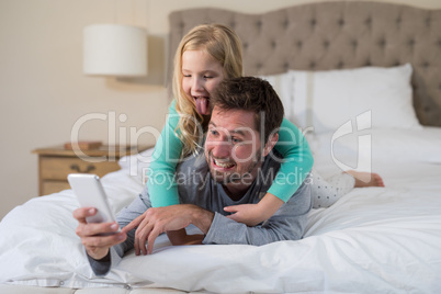 Father and daughter taking a selfie