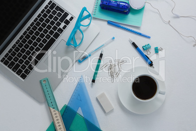 Laptop, black coffee and stationery on white background