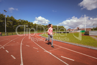 Woman jogging on a race track