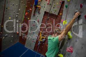 Dedicated athelets climbing wall in club