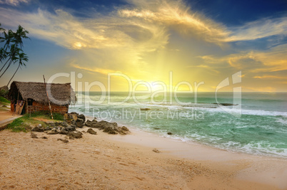 old fisherman's hut on shore of picturesque ocean and beautiful