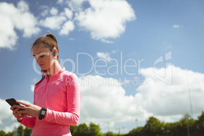 Woman using mobile phone on a sunny day