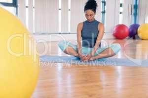 Woman performing yoga in the gym