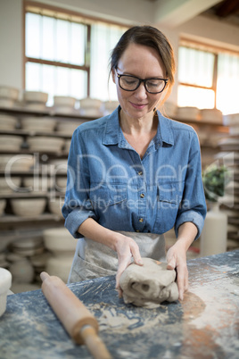 Female potter molding a clay