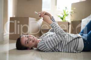 Woman using mobile phone while sleeping