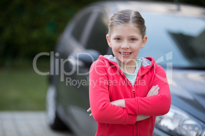 Teenage girl standing near the car