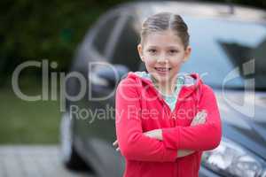 Teenage girl standing near the car