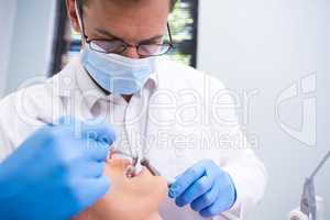 Close up of dentist examining patient